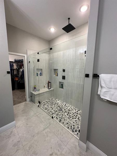Bathroom with tile floors and an enclosed shower