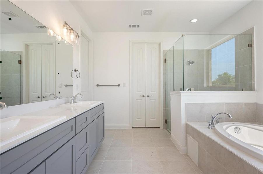 Bathroom featuring vanity, separate shower and tub, and tile patterned flooring