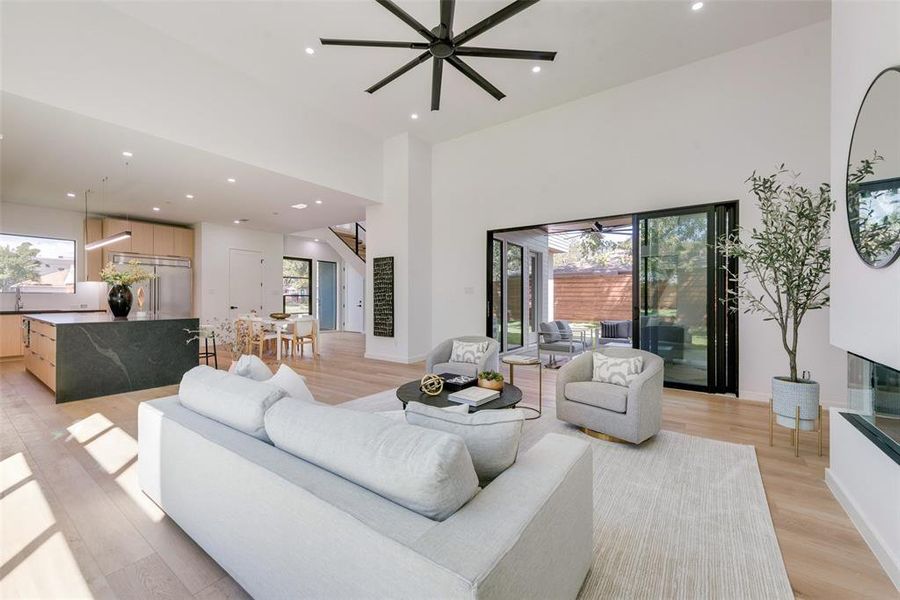 Living room featuring ceiling fan, light hardwood / wood-style floors, and a wealth of natural light