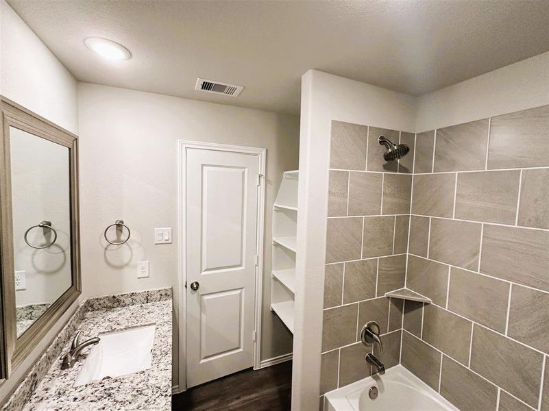 Bath 2 has extra linen shelves, granite counters, framed mirror & ceramic tile tub/shower walls