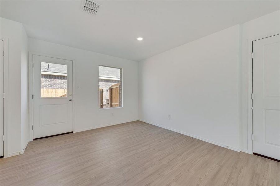 Foyer with light hardwood / wood-style floors