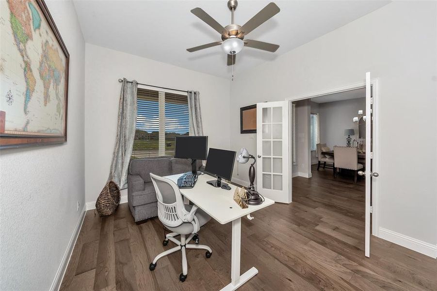 Home office featuring french doors, dark hardwood / wood-style floors, and ceiling fan