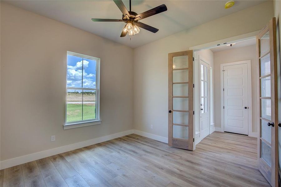 Spare room featuring ceiling fan and light wood-type flooring