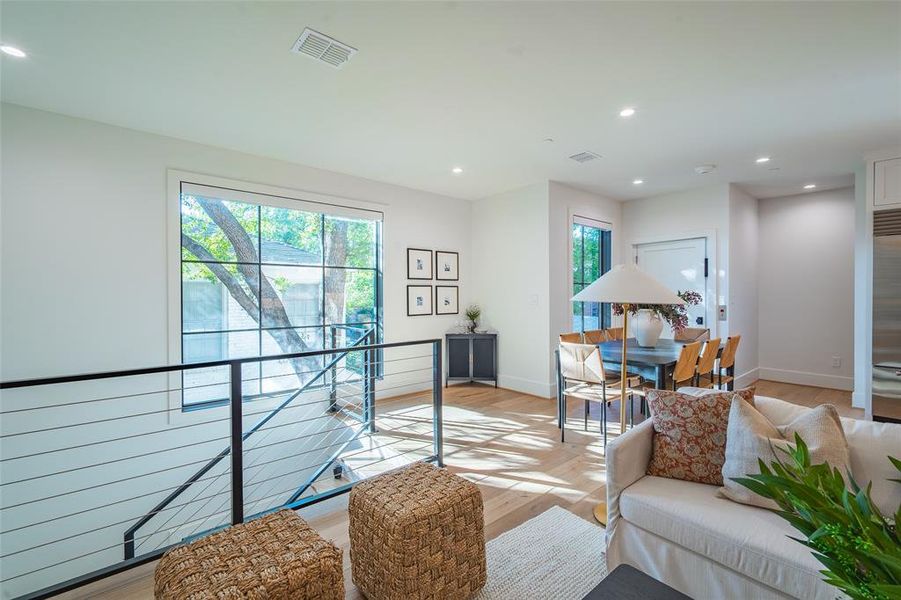 Living room featuring light hardwood / wood-style flooring and plenty of natural light