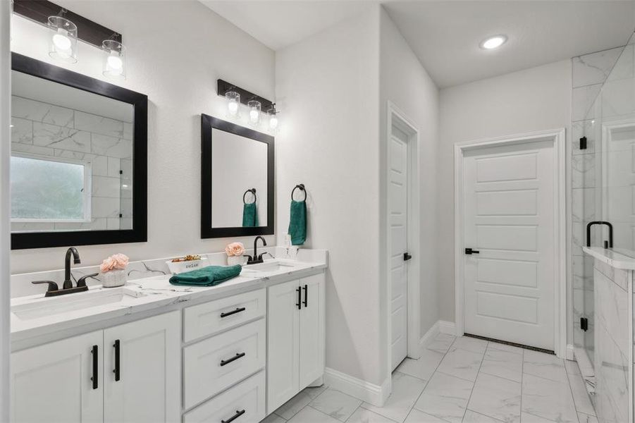 Bathroom featuring vanity and an enclosed shower