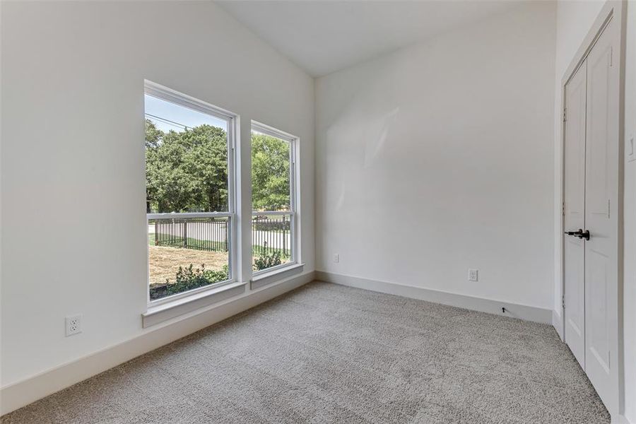 Carpeted bedroom featuring a healthy amount of sunlight