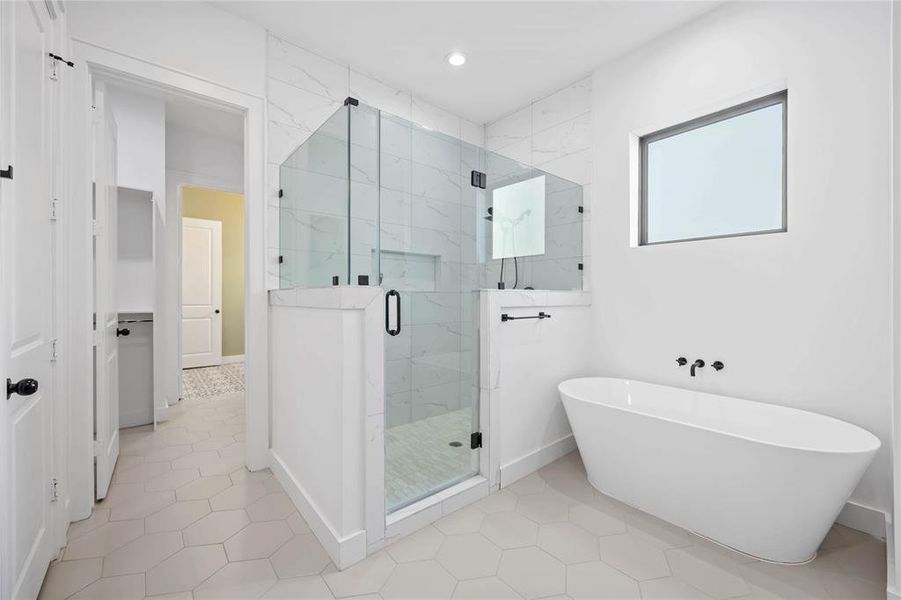 The primary bath features a large walk-in shower and soaking tub.