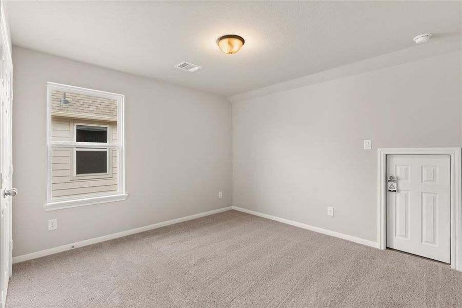 Your secondary bedroom features plush carpet, fresh paint, closet, and a large window that lets in plenty of natural lighting.