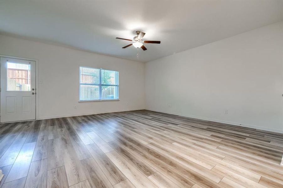 Empty room featuring ceiling fan and light wood-type flooring