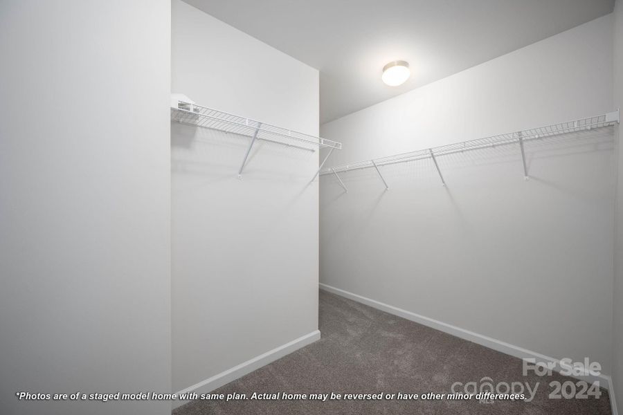 Primary bedroom walk-in closet