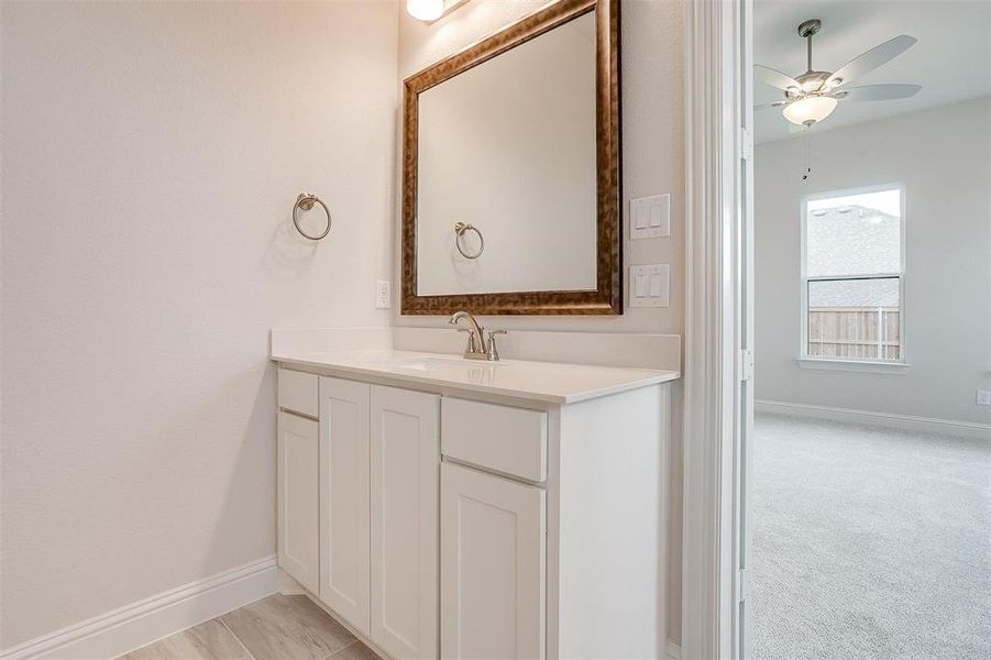 Bathroom featuring ceiling fan and vanity