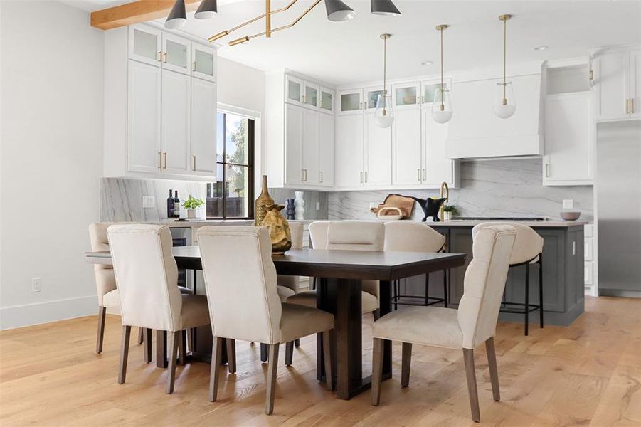 Dining area featuring light hardwood / wood-style floors and beam ceiling