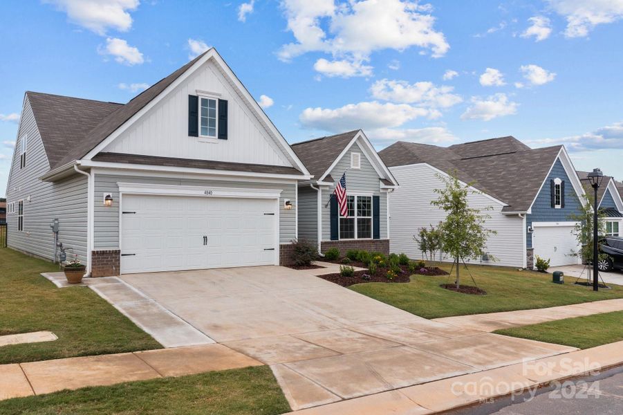 Front of home on a rainy, rainy day.  Notice the extended driveway and trash receptical pad for ease of use, unloading and maneuvering!  It's the details that make the difference!