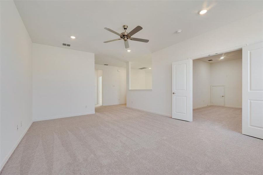 Carpeted spare room with ceiling fan