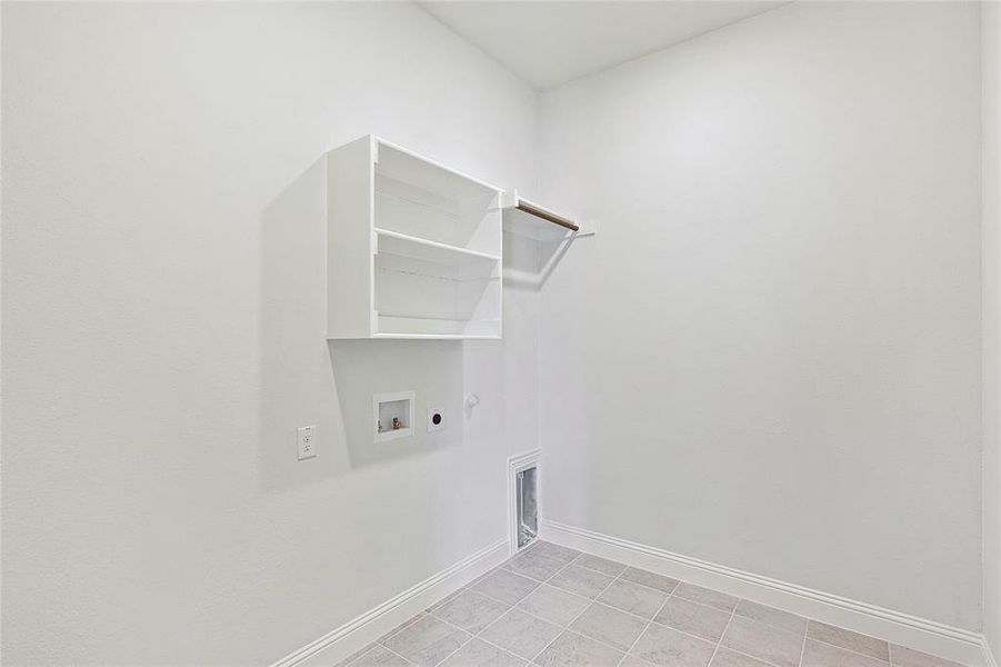 Washroom featuring light tile patterned flooring, electric dryer hookup, gas dryer hookup, and hookup for a washing machine