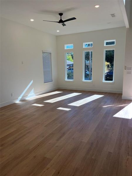 Unfurnished room with dark hardwood / wood-style floors and ceiling fan