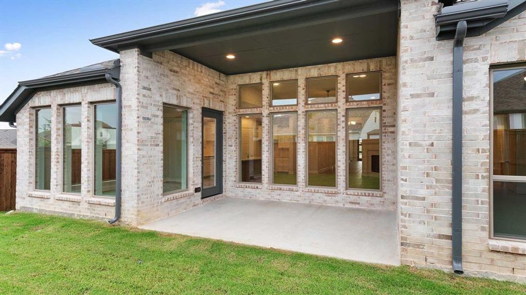 Entrance to property with a patio area and a yard