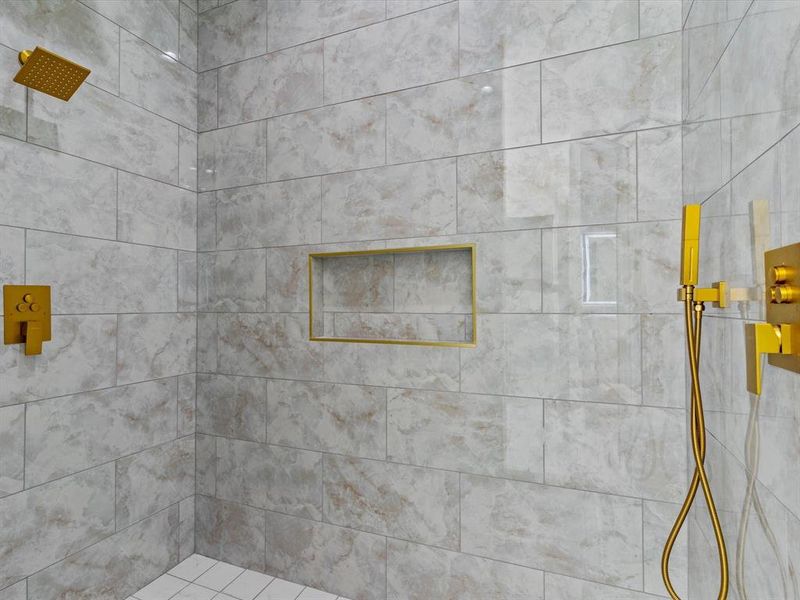 Bathroom featuring a tile shower