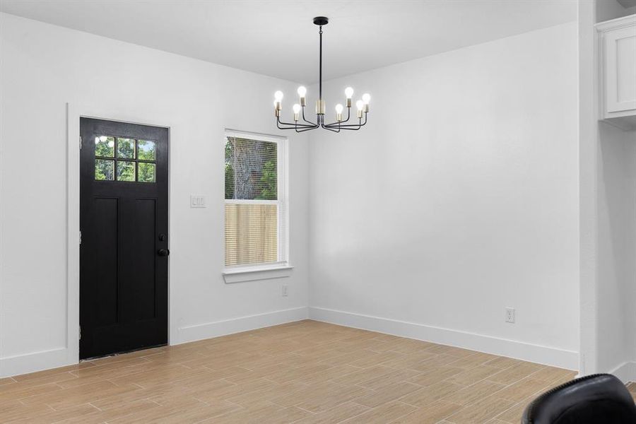 Foyer featuring a notable chandelier and light hardwood / wood-style flooring