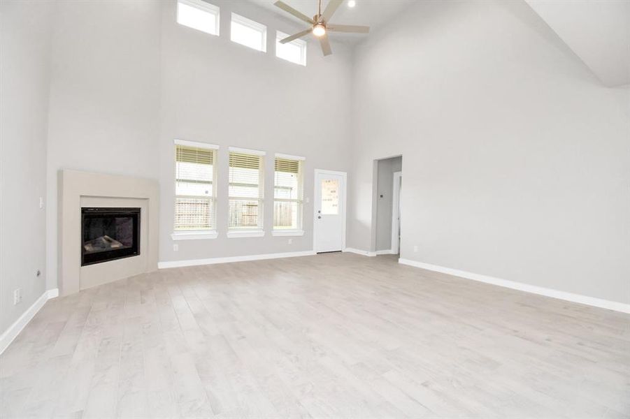 Another view of the spacious family room. Sample photo of completed home with similar floor plan. Actual colors and selections may vary.