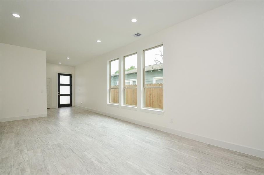 Upon entering you find beautiful floors, high ceilings, and ample recessed lighting!