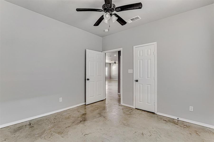 Spare room featuring concrete floors and ceiling fan