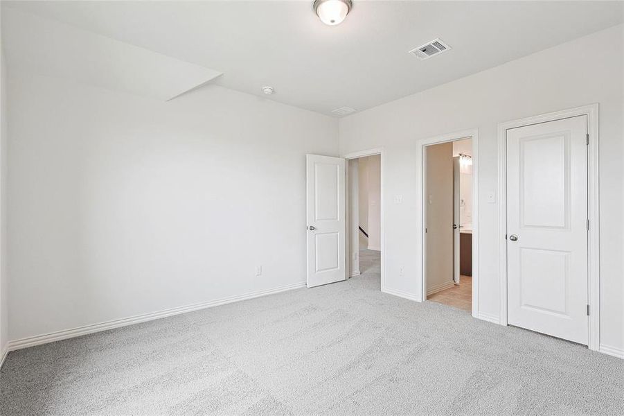 Unfurnished bedroom featuring light carpet