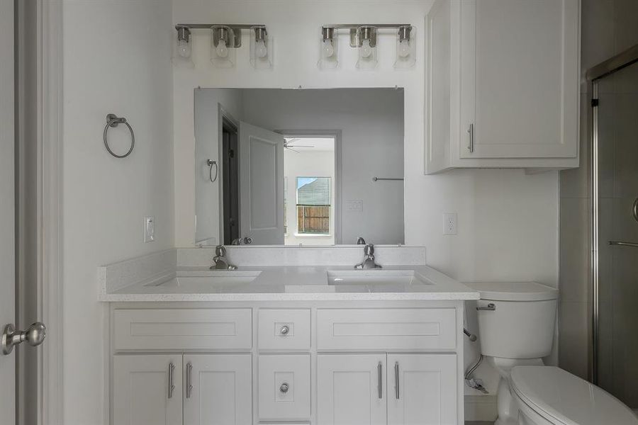 Bathroom with ceiling fan, vanity, toilet, and an enclosed shower