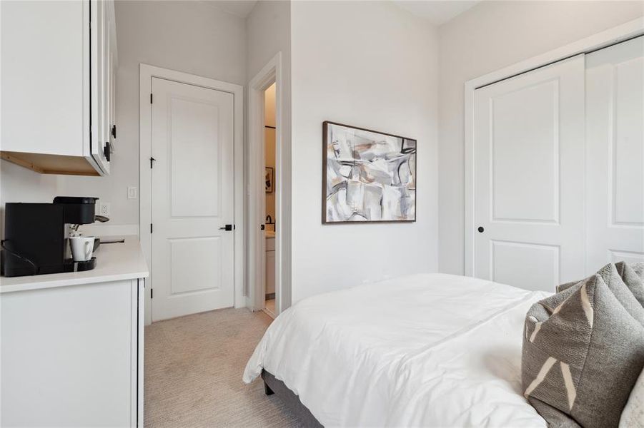 This bedroom features a versatile sink and cabinet space, perfect for storing dishes or other essentials. Ideal for an Airbnb or mother-in-law suite, it offers guests convenient amenities.