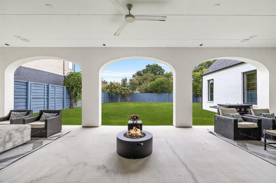 View of patio / terrace with ceiling fan and a fire pit