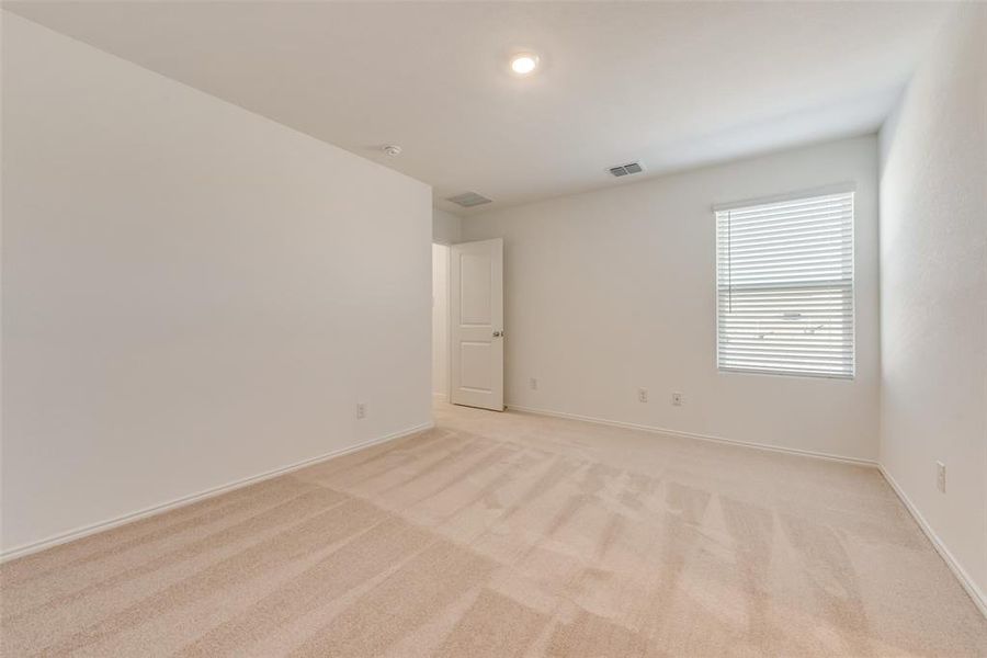 Spare room featuring light colored carpet