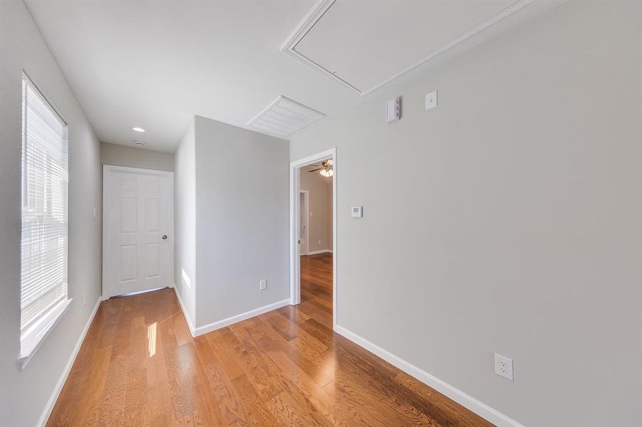 The hallway beautifully connects all the bedrooms, showcasing the home's thoughtful layout and seamless flow. Each room offers its own unique charm while benefiting from easy access to shared spaces. This design fosters a sense of togetherness, making it perfect for family living while maintaining privacy and comfort for everyone.