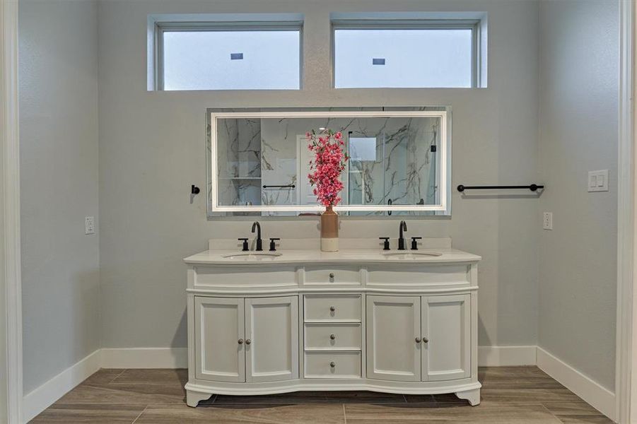 Beautiful double vanity with LED touch light mirror. Transom windows add natural light.
