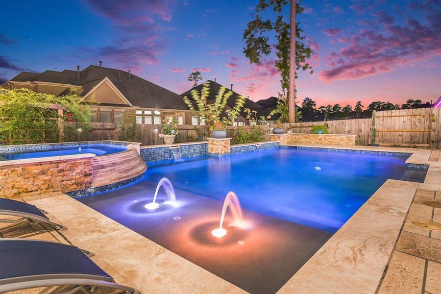 Professionally landscaped yard with garden lights illuminating the home in the evenings