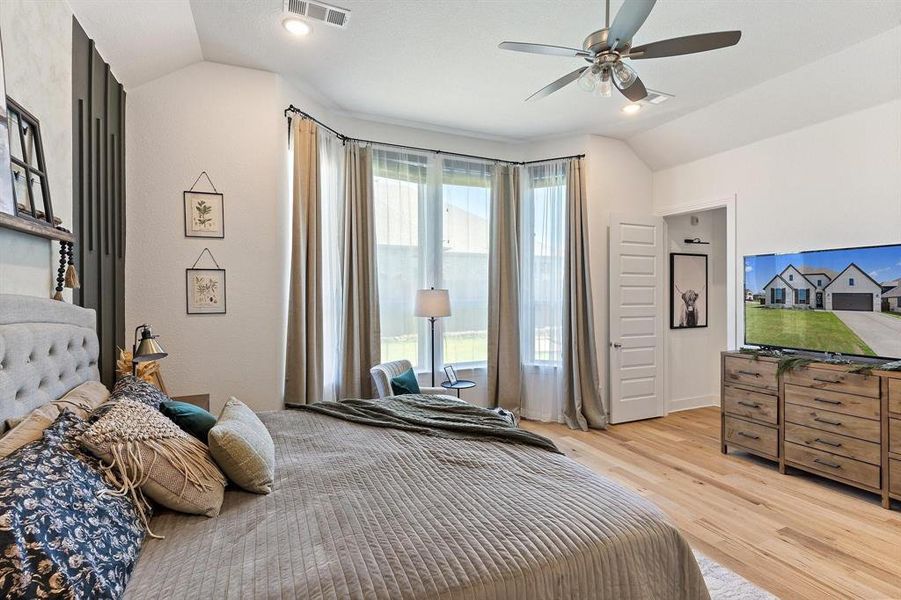 Bedroom featuring lofted ceiling, light hardwood / wood-style flooring, and ceiling fan