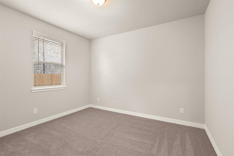 Your secondary bedroom features plush carpet, fresh paint, closet, and a large window that lets in plenty of natural lighting.