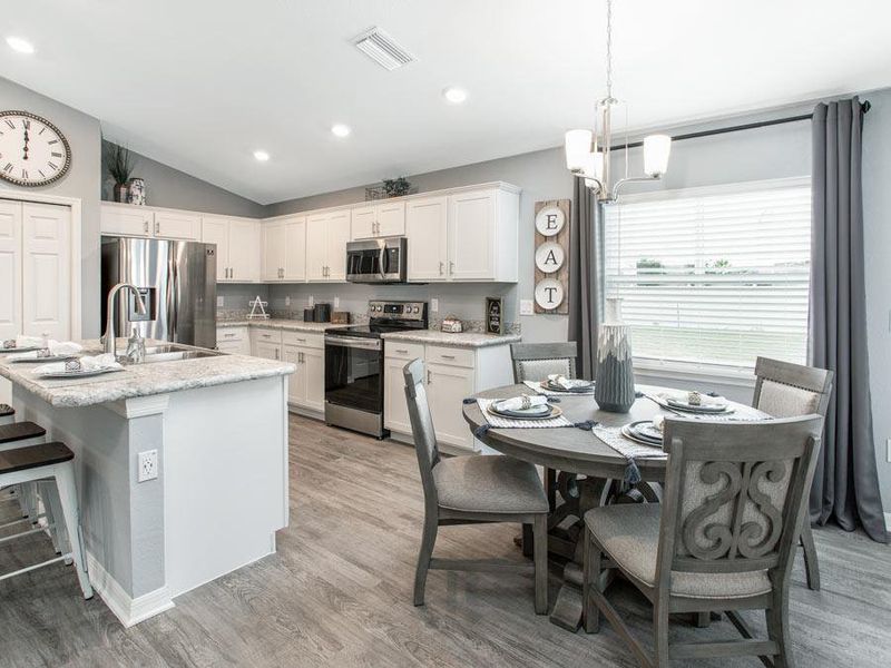 Your kitchen and dining cafe are fully open to the gathering room - Begonia home plan by Highland Homes