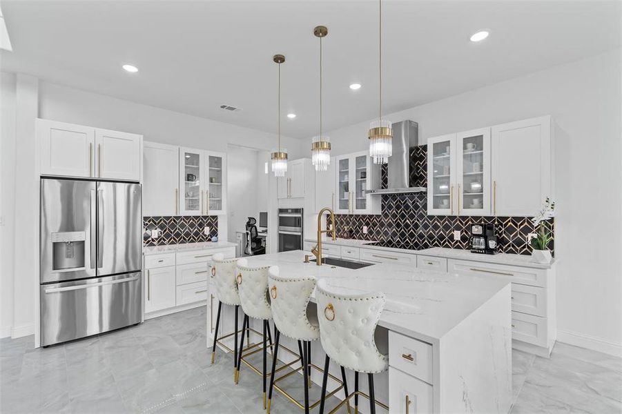 Kitchen featuring sink, a kitchen island with sink, exhaust hood, appliances with stainless steel finishes, and decorative backsplash