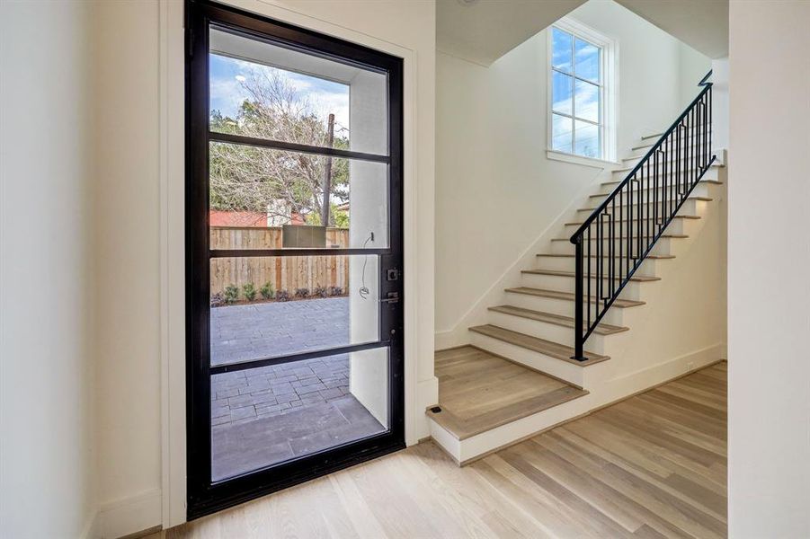 Step inside and you will notice the beautiful staircase with wood treads and beautiful iron railing.