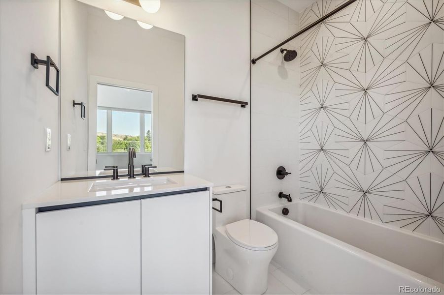 Full Bathroom En-Suite to Secondary Bedroom Features Modern Tile, Finishes and Fixtures.