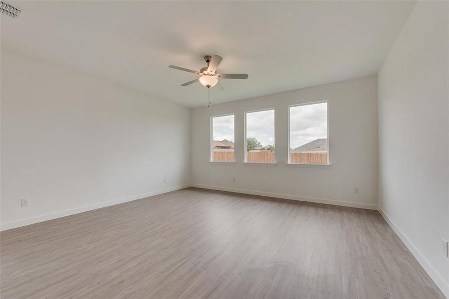 Unfurnished room with light wood-type flooring and ceiling fan