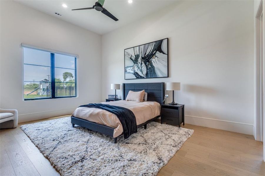 Bedroom with ceiling fan and light hardwood / wood-style floors