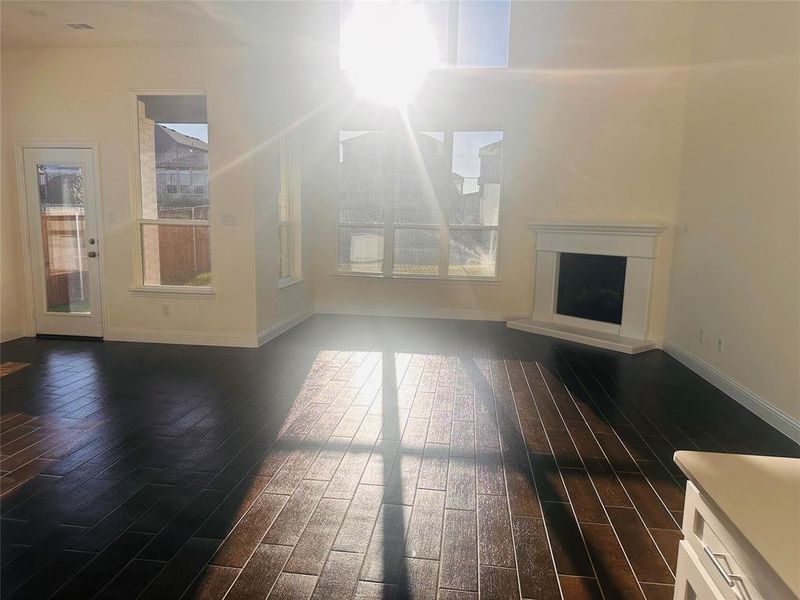 Unfurnished living room featuring dark hardwood / wood-style floors