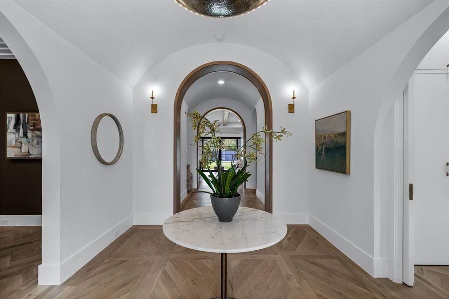 Entrance foyer with light parquet floors and lofted ceiling