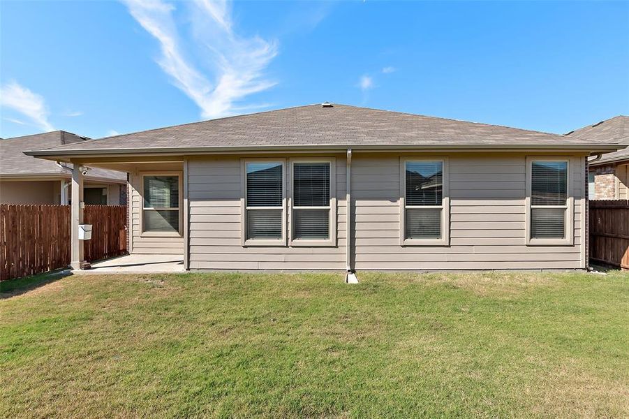 Rear view of house with a yard