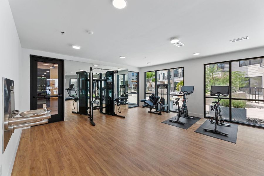 Fitness studio with free weights, cardio equipment, and more