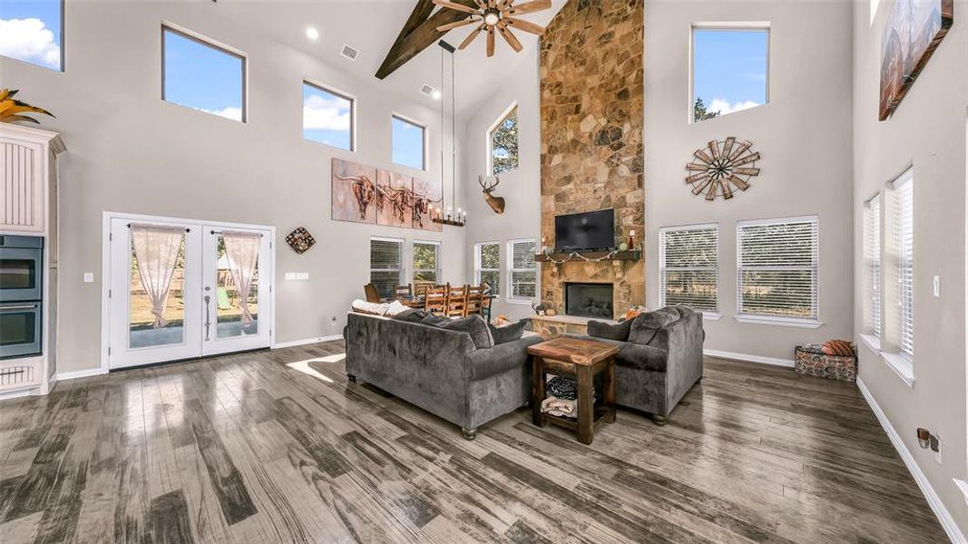 The open living and dining area features a stunning floor-to-ceiling stone gas fireplace, creating a warm and inviting focal point for gatherings and cozy evenings.