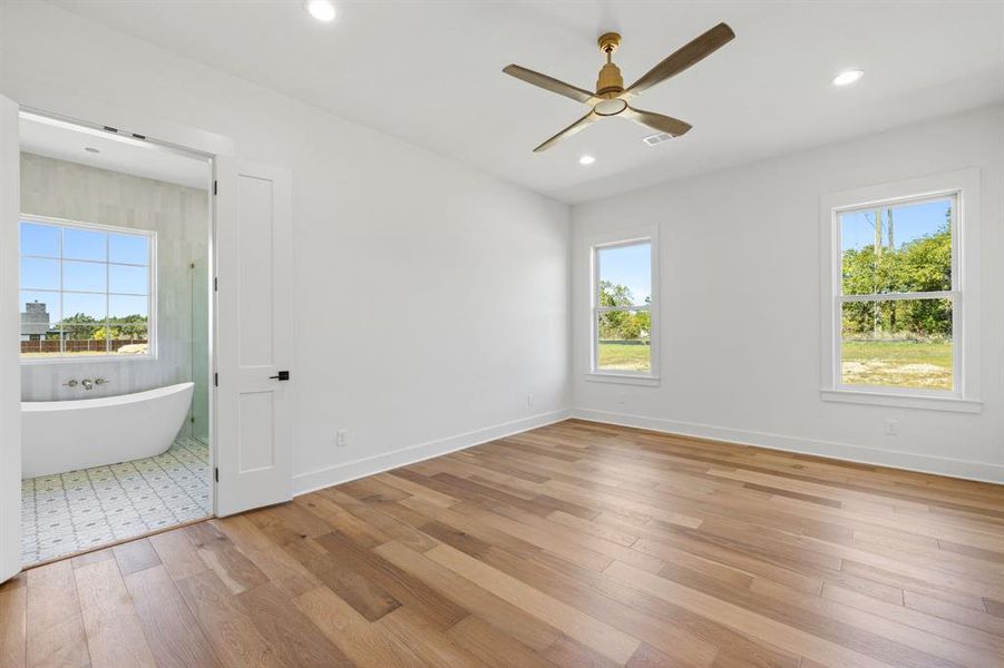 Unfurnished bedroom featuring light wood-type flooring and ceiling fan