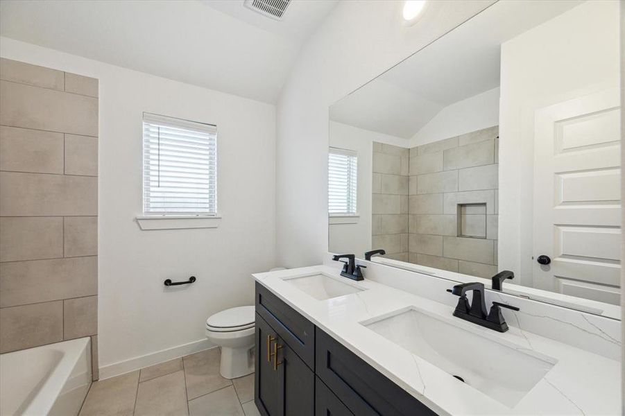 This dual vanity bathroom combines style and functionality, providing ample space for morning routines. The minimalist design is complemented by quality fixtures and a relaxing color scheme.