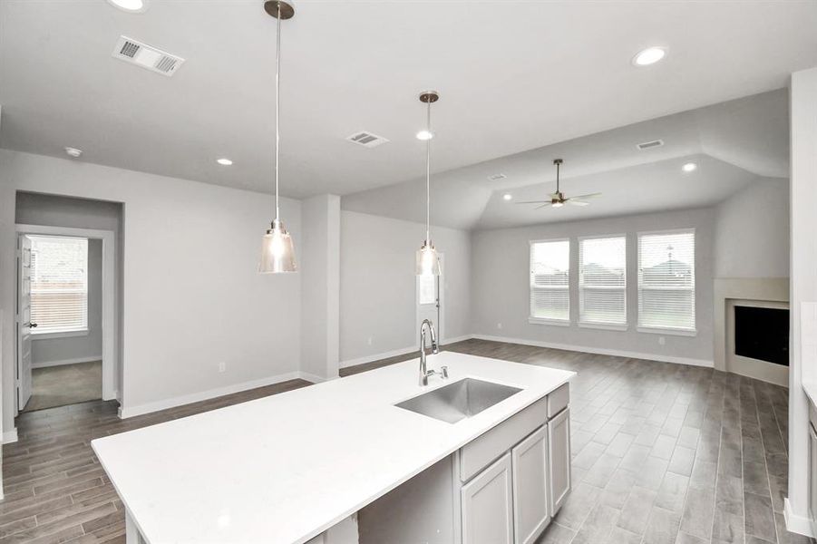 Discover another perspective of this stunning kitchen, generously appointed with an abundance of counter space. Sample photo of completed home with similar floor plan. As-built interior colors and selections may vary.